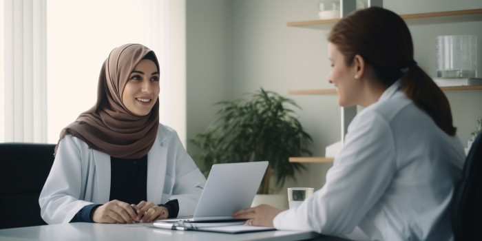 A woman consults with turkish doctor in an offi