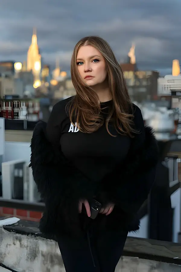 Anna Delvey poses for a photo at her home